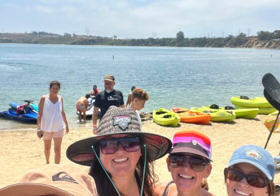 Family paddleboarding at the Carlsbad Lagoon near Ocean Hills Country Club